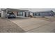 Front view of a home with a paved driveway and covered parking with desert landscaping at 9709 E Empress Ave, Mesa, AZ 85208