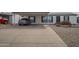 View of the home with a paved driveway and covered parking featuring attractive desert landscaping at 9709 E Empress Ave, Mesa, AZ 85208
