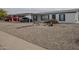 Charming home featuring low maintenance rock landscaping and a covered parking area at 9709 E Empress Ave, Mesa, AZ 85208
