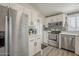 Well-designed kitchen featuring stainless steel appliances, white cabinets, and quartz countertops at 9709 E Empress Ave, Mesa, AZ 85208