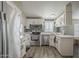 Well-designed kitchen featuring stainless steel appliances, white cabinets, and quartz countertops at 9709 E Empress Ave, Mesa, AZ 85208