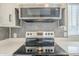 Electric range with stainless steel microwave and quartz countertops at 9709 E Empress Ave, Mesa, AZ 85208