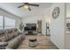 Spacious living room featuring modern ceiling fan, neutral paint, and wood-look floors at 9709 E Empress Ave, Mesa, AZ 85208