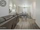 Open-concept living room flowing into dining and kitchen areas with attractive vinyl floors at 9709 E Empress Ave, Mesa, AZ 85208