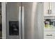 Close-up of stainless steel refrigerator with water dispenser, and bright kitchen at 9709 E Empress Ave, Mesa, AZ 85208