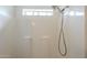 Modern shower stall features a handheld shower head and built in shelving at 9709 E Empress Ave, Mesa, AZ 85208