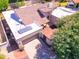 Aerial view of property with tile roof, three car garage, lush landscaping, and gated entrance at 9740 E Gold Dust Ave, Scottsdale, AZ 85258