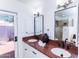 Bright bathroom features dual sinks, granite countertops, and a door leading to the outdoors at 9740 E Gold Dust Ave, Scottsdale, AZ 85258