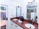 Bright bathroom features dual sinks, granite countertops, and a door leading to the outdoors at 9740 E Gold Dust Ave, Scottsdale, AZ 85258