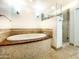 Spacious bathroom featuring a soaking tub, glass-enclosed shower, and tile accents at 9740 E Gold Dust Ave, Scottsdale, AZ 85258