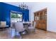 Bright dining area with designer lighting, stylish table setting, and seamless patio access for indoor-outdoor living at 9740 E Gold Dust Ave, Scottsdale, AZ 85258