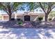 Charming home with a decorative iron gate, brick walkway, and manicured landscaping at 9740 E Gold Dust Ave, Scottsdale, AZ 85258