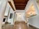 Grand foyer features columns, wood beam ceiling, and tile floors leading to the front door and adjacent living spaces at 9740 E Gold Dust Ave, Scottsdale, AZ 85258