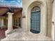 Charming front door with an arched transom window and a welcoming covered entryway at 9740 E Gold Dust Ave, Scottsdale, AZ 85258