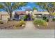 Stunning home featuring desert landscaping, mature trees, and an arched entryway at 9740 E Gold Dust Ave, Scottsdale, AZ 85258