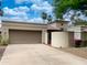 Desert home with a two-car garage, mature trees and low maintenance yard at 9740 E Gold Dust Ave, Scottsdale, AZ 85258
