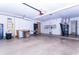 Organized garage featuring built-in cabinets, epoxy flooring, workbench, and ample storage at 9740 E Gold Dust Ave, Scottsdale, AZ 85258