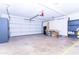 Spacious garage with ample storage cabinets, work table, and epoxy floors at 9740 E Gold Dust Ave, Scottsdale, AZ 85258