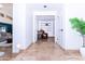 Hallway with travertine tile flooring leads to a seating area at 9740 E Gold Dust Ave, Scottsdale, AZ 85258