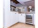 Features white cabinets, granite countertops, and a stainless steel wine cooler for elegant entertaining at 9740 E Gold Dust Ave, Scottsdale, AZ 85258