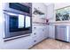 Modern kitchen featuring stainless steel appliances, double ovens, and ample storage within light grey cabinetry at 9740 E Gold Dust Ave, Scottsdale, AZ 85258