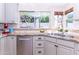 Sunny kitchen featuring stainless steel appliances, undermount sink, and a view of the lush backyard at 9740 E Gold Dust Ave, Scottsdale, AZ 85258
