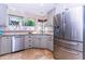 Modern kitchen features stainless steel appliances, light grey cabinetry, and a window providing ample natural light at 9740 E Gold Dust Ave, Scottsdale, AZ 85258