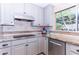 Beautiful kitchen featuring stainless steel appliances, sleek cooktop, and granite countertops with tiled backsplash at 9740 E Gold Dust Ave, Scottsdale, AZ 85258
