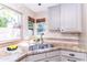 Bright kitchen features a stainless steel sink, granite countertops, and natural light from the window at 9740 E Gold Dust Ave, Scottsdale, AZ 85258