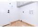 Spacious laundry room featuring tile flooring, white walls, and access to the garage or backyard at 9740 E Gold Dust Ave, Scottsdale, AZ 85258