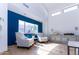 Bright living room boasts blue accent wall, clerestory windows, and comfortable chairs at 9740 E Gold Dust Ave, Scottsdale, AZ 85258