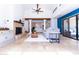 Bright living room with fireplace, high ceilings and access to outdoor patio at 9740 E Gold Dust Ave, Scottsdale, AZ 85258