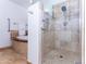 Spa-like bathroom with a walk-in shower, tiled walls, and a relaxing soaking tub in the background at 9740 E Gold Dust Ave, Scottsdale, AZ 85258