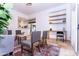 Inviting sitting area with chairs, couch, built-in shelving and travertine flooring at 9740 E Gold Dust Ave, Scottsdale, AZ 85258