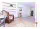 Sitting area features a leather chair, built-in shelves, and travertine floors at 9740 E Gold Dust Ave, Scottsdale, AZ 85258