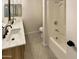 Modern bathroom featuring double sinks, a large mirror, updated fixtures, and a shower-tub combo, providing comfort and style at 9814 N Balboa Dr, Sun City, AZ 85351