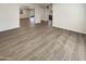 A view of the open floor plan, with attractive wood floors, showcasing the home's spacious layout and natural light at 9814 N Balboa Dr, Sun City, AZ 85351