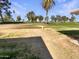 Scenic view of a lush green golf course with mature trees and blue skies at 9814 N Balboa Dr, Sun City, AZ 85351