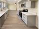 Updated kitchen with gray cabinets, modern stainless steel appliances, and an open layout perfect for cooking and entertaining at 9814 N Balboa Dr, Sun City, AZ 85351