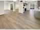 Open-concept living room showcasing durable floors and seamless flow to the kitchen at 9814 N Balboa Dr, Sun City, AZ 85351
