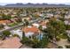 View from above showcases mountain views, neighborhood, mature trees and a tile roof at 10435 N 98Th St, Scottsdale, AZ 85258