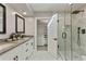 Bright bathroom featuring a double vanity, glass shower and walk-in closet at 10435 N 98Th St, Scottsdale, AZ 85258