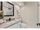 Clean bathroom featuring a white vanity with gray countertop, contemporary mirror, and a modern toilet at 10435 N 98Th St, Scottsdale, AZ 85258