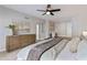 Bright bedroom with a large wood dresser, plush bedding, and seamless access to additional living space at 10435 N 98Th St, Scottsdale, AZ 85258