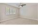 Neutral bedroom with a ceiling fan, plush carpet, and a window with shutter offering ample natural light at 10435 N 98Th St, Scottsdale, AZ 85258
