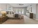 Serene bedroom with soft, natural light, plush bedding and a view of lush landscaping through shuttered doors at 10435 N 98Th St, Scottsdale, AZ 85258