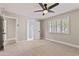 Neutral bedroom with a ceiling fan, plush carpet, and a window with shutter offering ample natural light at 10435 N 98Th St, Scottsdale, AZ 85258