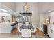 Open concept dining room with modern light fixture and a bar with wine cooler at 10435 N 98Th St, Scottsdale, AZ 85258