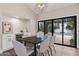 Bright dining area with backyard pool view, modern light fixture, built-in bar, and wine storage at 10435 N 98Th St, Scottsdale, AZ 85258