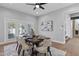 Bright dining room with modern table, stylish chairs, and doors to the outdoor area at 10435 N 98Th St, Scottsdale, AZ 85258